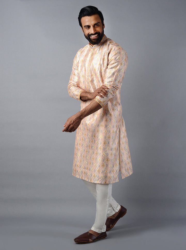 Celebrate in style with this chic peach kurta set, tailored for modern events.