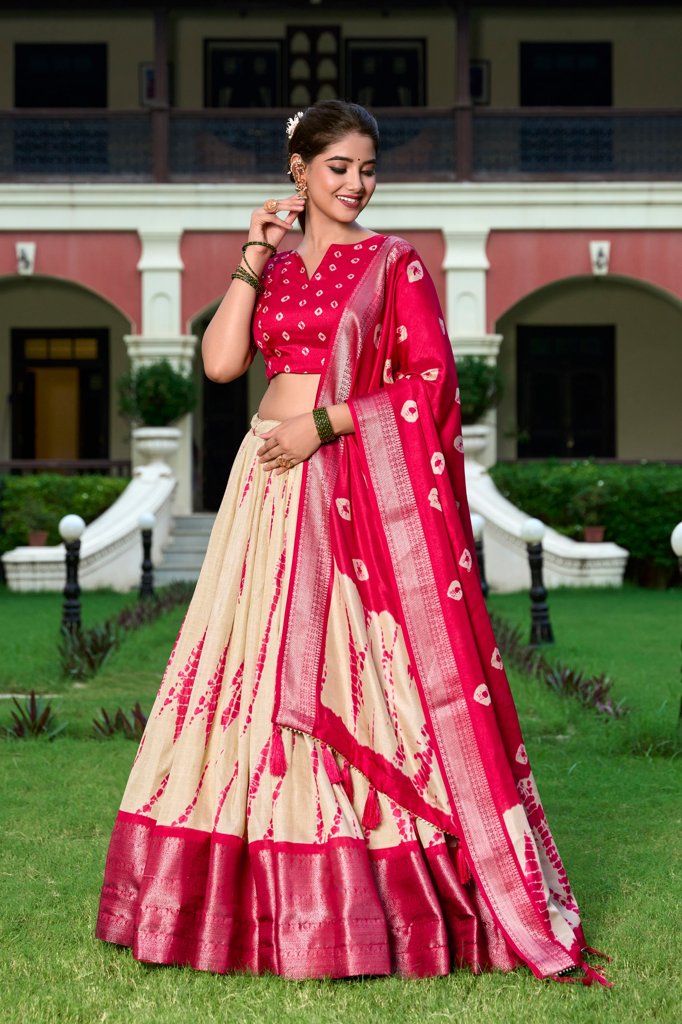 Vibrant red Dola silk lehenga set with intricate Shibori print and zari weaving, perfect for festive occasions.