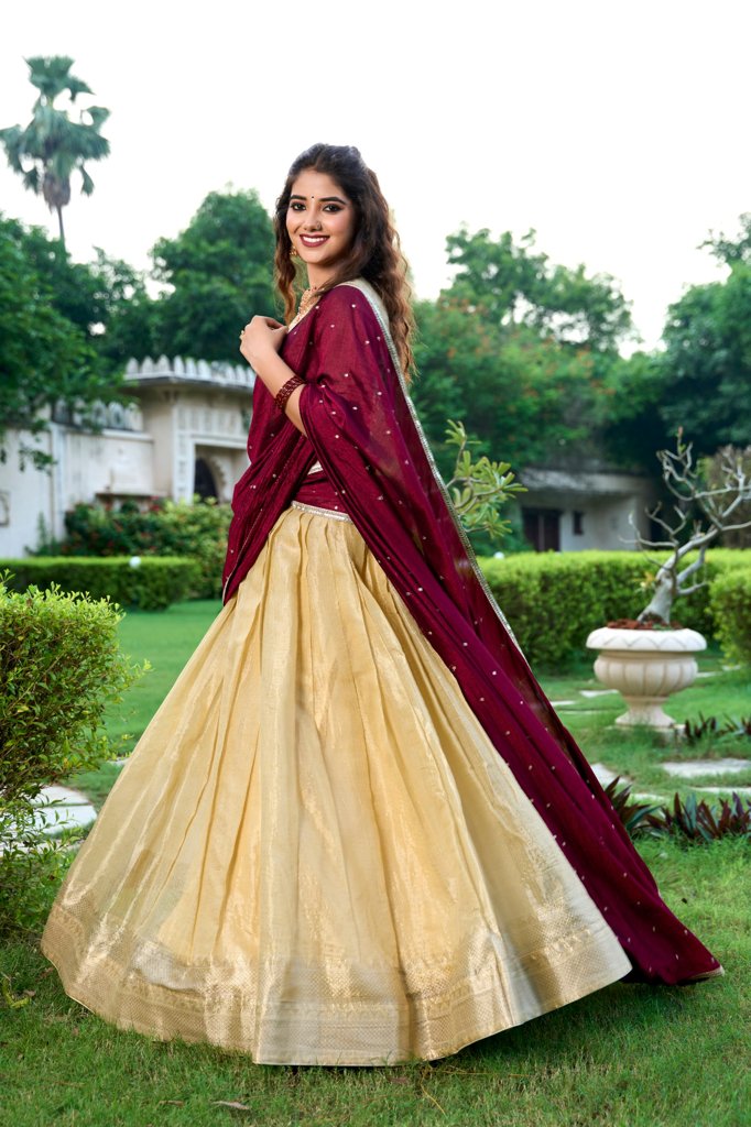 Classic cream Kanchipuram lehenga design with gold accents and unstitched blouse.