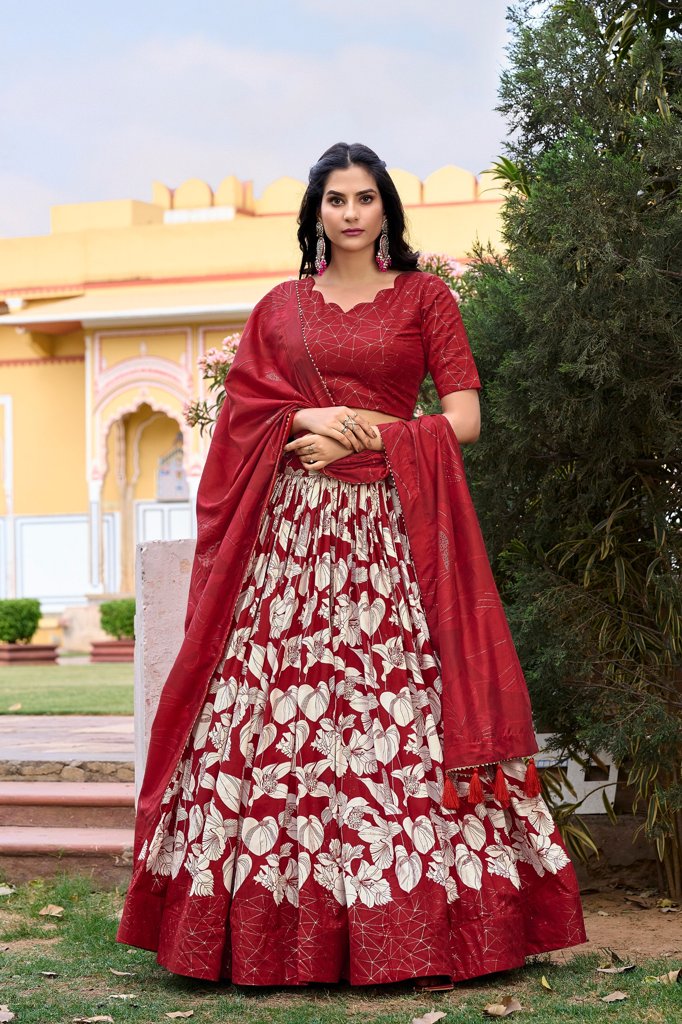 Elegant red Tussar silk floral lehenga with foil print and tassel details, perfect for weddings.