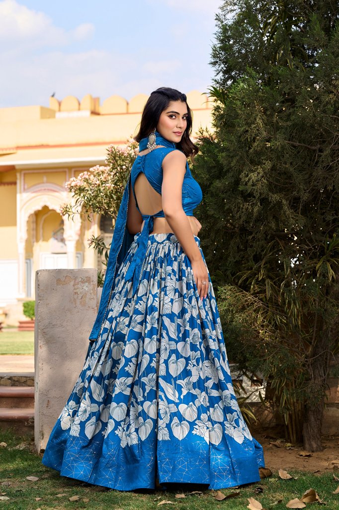 Elegant blue Tussar silk floral lehenga with foil print, tassels, and zip closure, perfect for weddings.