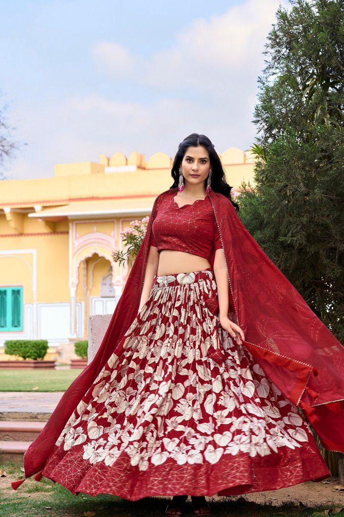 Traditional red Tussar silk lehenga with beautiful floral design, zip closure, and tassels.