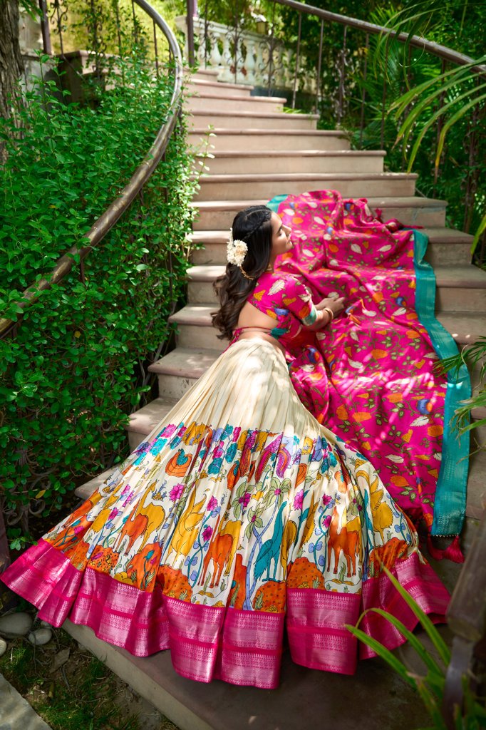 Stunning white Kalamkari print lehenga with delicate floral patterns and a matching silk blouse.