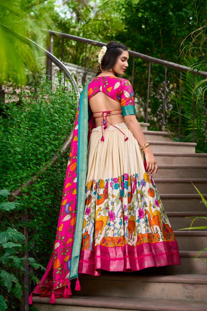 Traditional white Dola silk lehenga with Kalamkari prints and stylish blouse, ideal for festive wear.