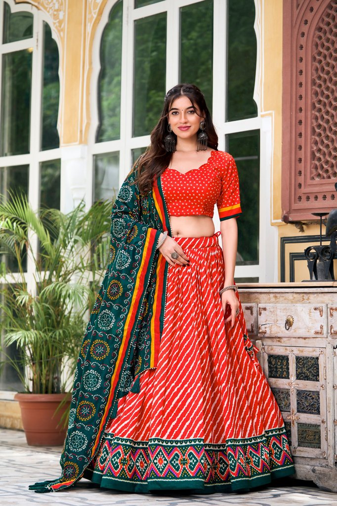 Elegant red Tussar silk lehenga set with Leheriya pattern and traditional Patola border for weddings.