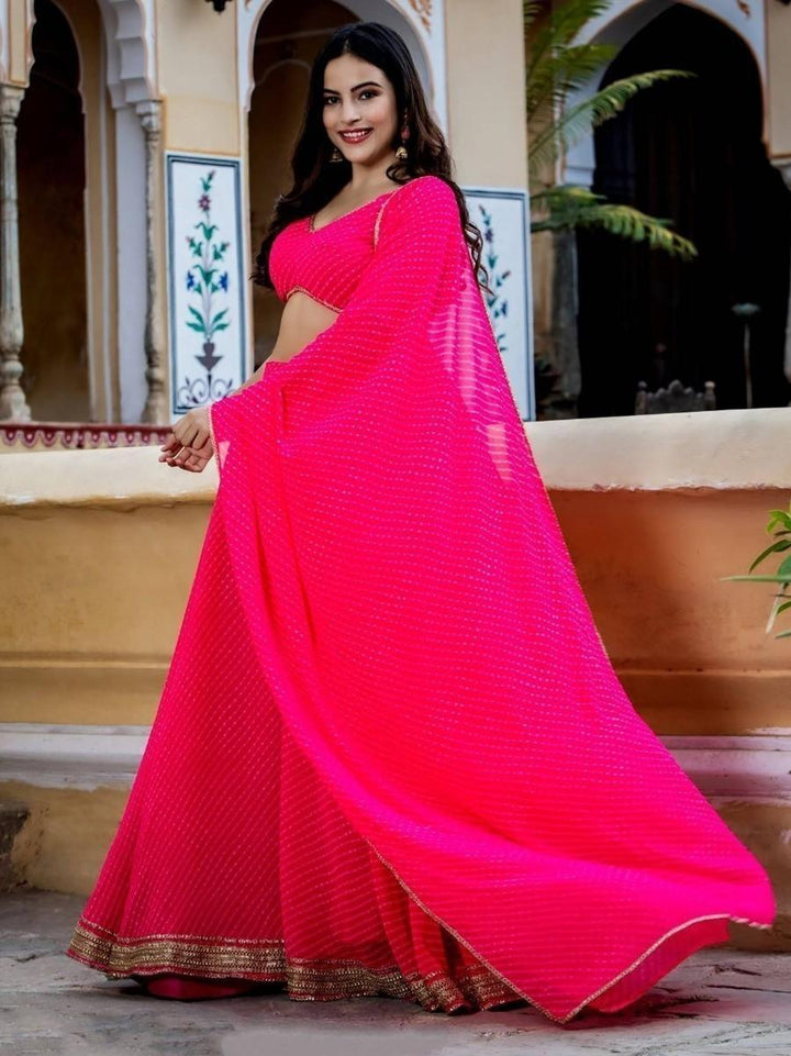 Elegant pink lehenga dress with lace work and matching dupatta.