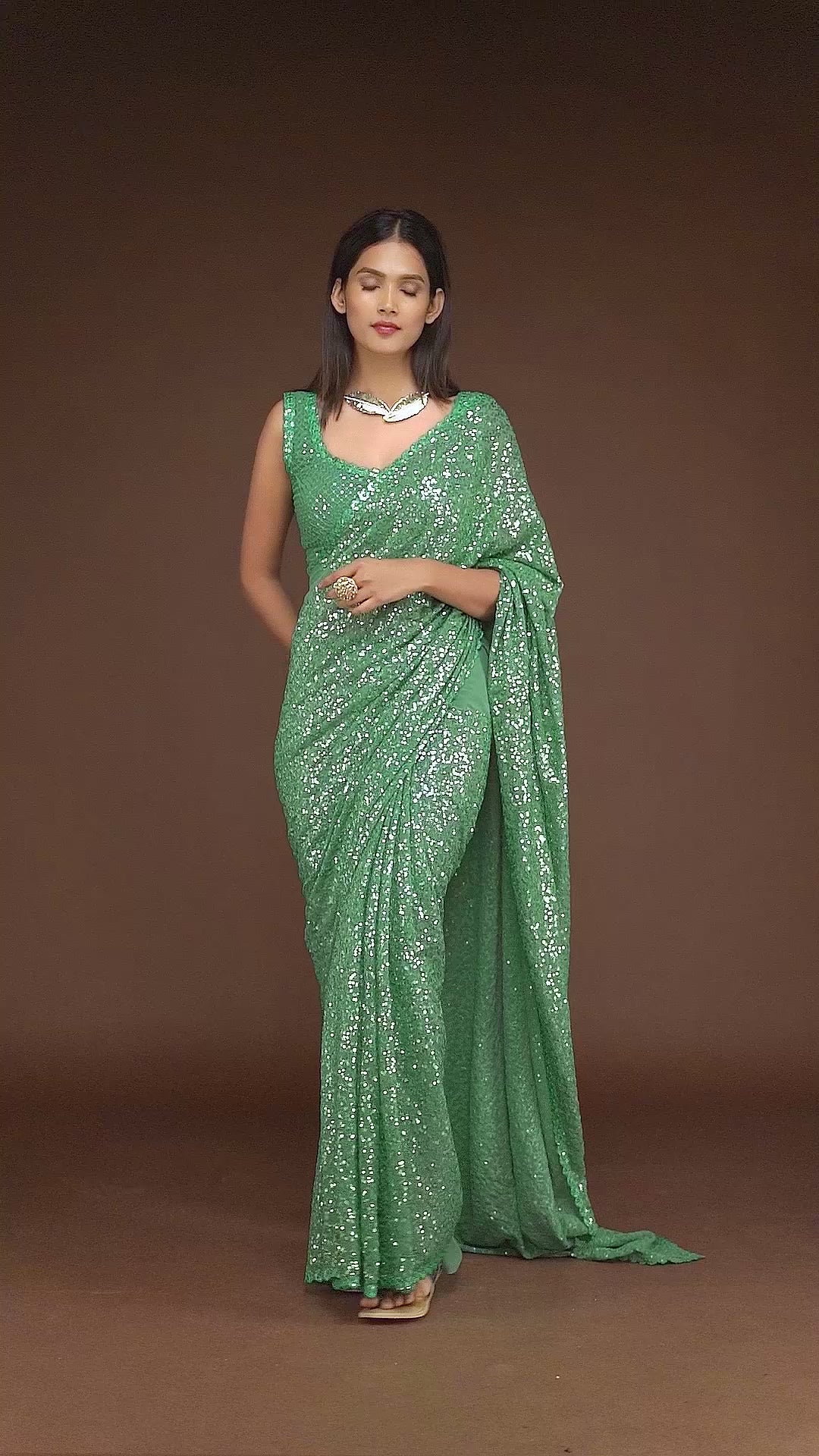 A chic mint green saree featuring delicate sequins embroidery, exuding elegance and charm, making it a perfect choice for cultural gatherings and traditional Indian sari events.