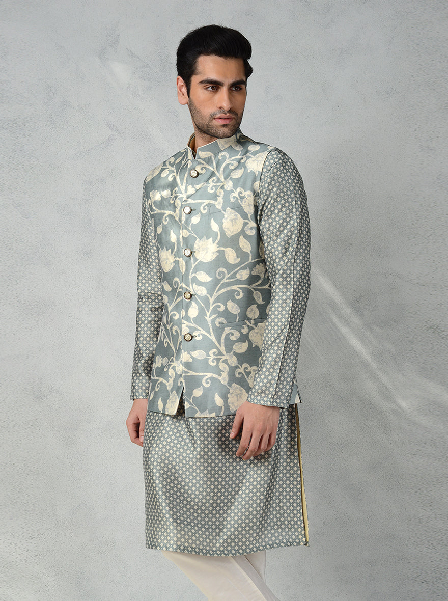 This elegant deep dusky mint green Jodhpuri jacket features muga silk and a unique floral design, making it perfect for any occasion.