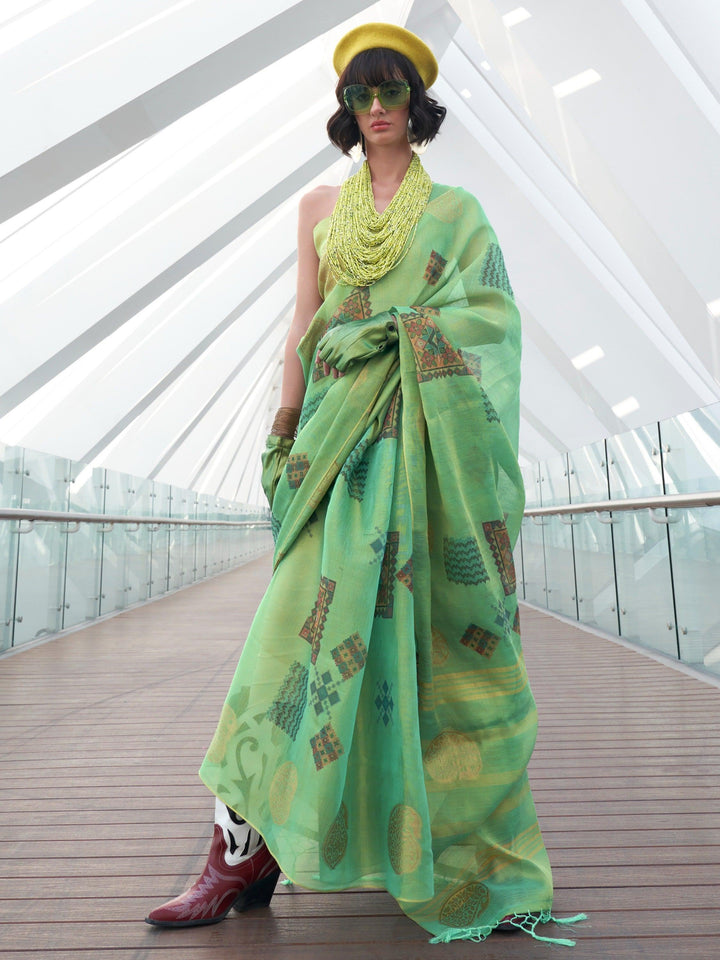 Green luxurious fabric saree crafted for elegance and style.