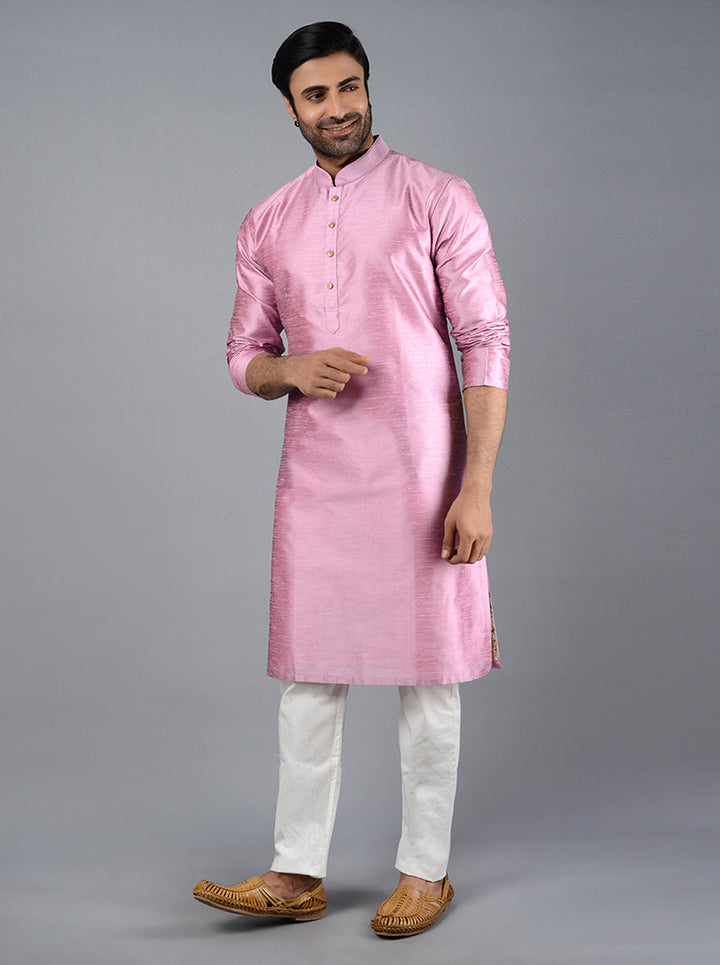 Stylish onion pink kurta set crafted from silk blend fabric, featuring refined embroidery for a festive look.