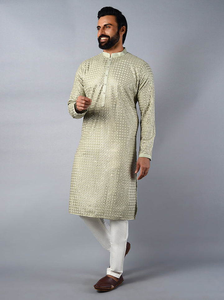 Stylish pista green kurta set crafted from silk blend, adorned with badla embroidery for a festive look.