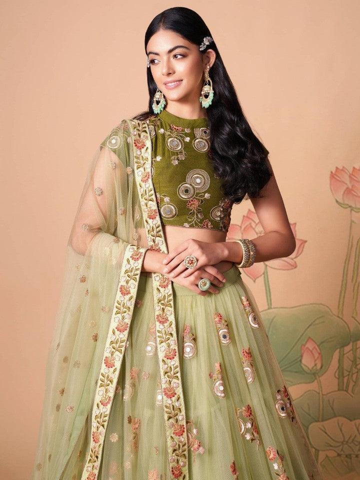 Traditional pastel green lehenga choli with intricate embroidery.