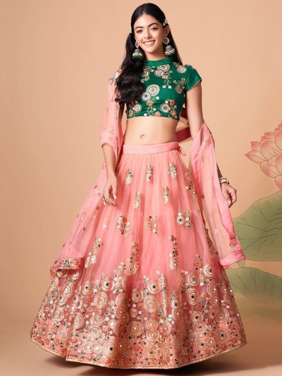 Peach net lehenga with mirror work and thread embroidery.