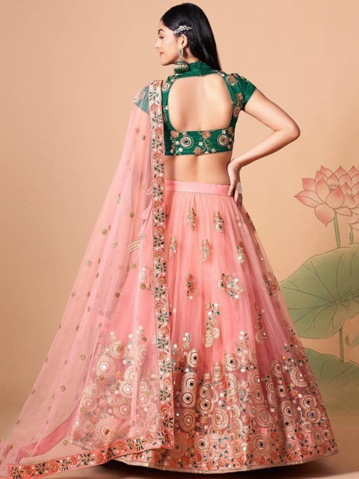 Peach lehenga with net material and intricate mirror work.