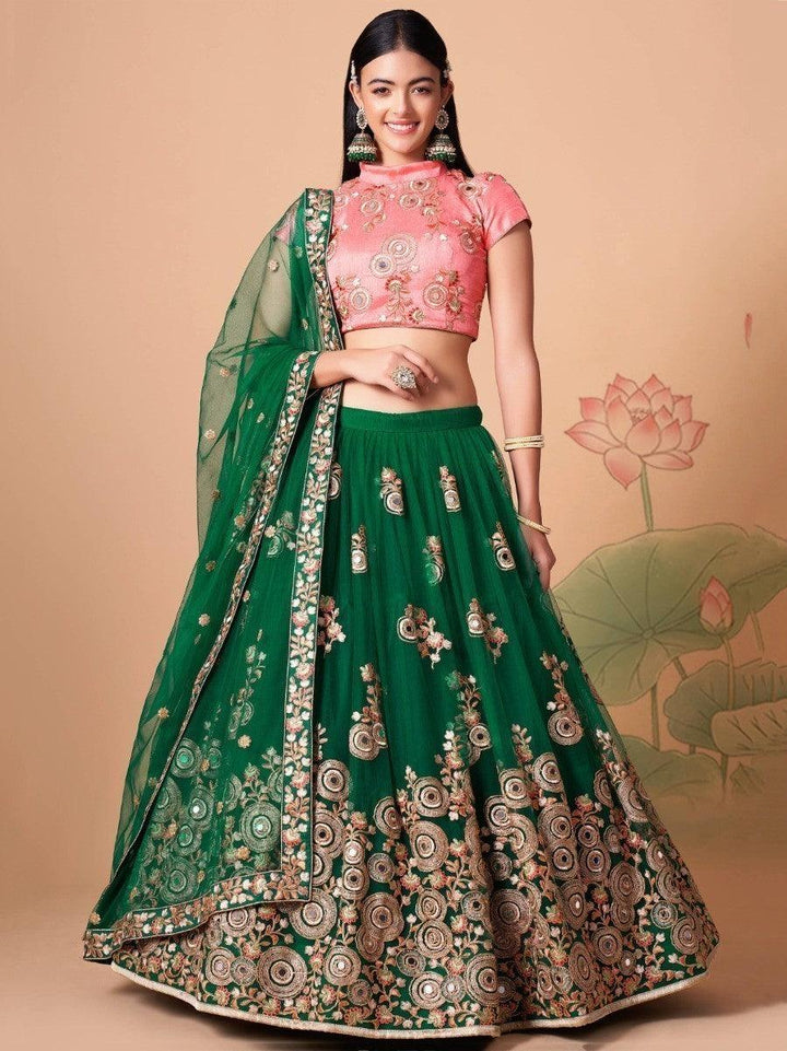 Green net lehenga with mirror work and embroidery details.