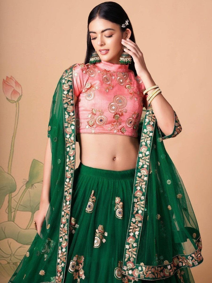 Green net lehenga with pink embroidered choli for weddings.