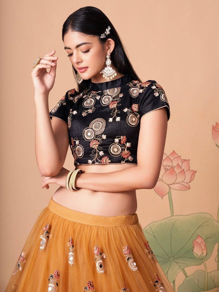 Classic gold lehenga choli with detailed mirror work and embroidery.