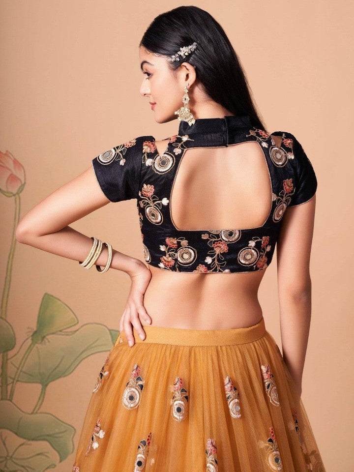 Semi-stitched gold lehenga with mirror and sequin embellishments.