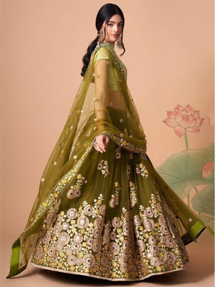 Bridal lehenga with olive green net fabric and mirror work accents.