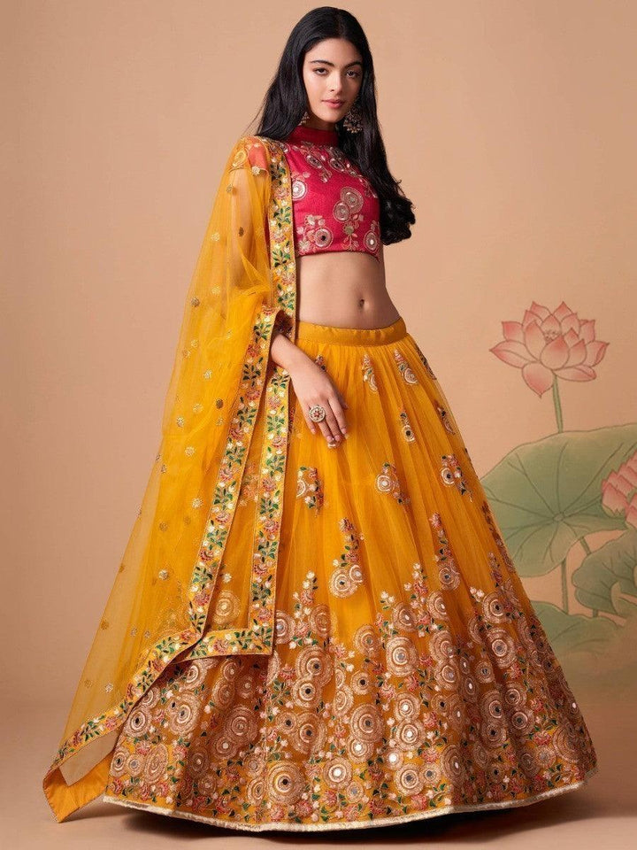 Elegant yellow lehenga with matching hot pink choli and dupatta.