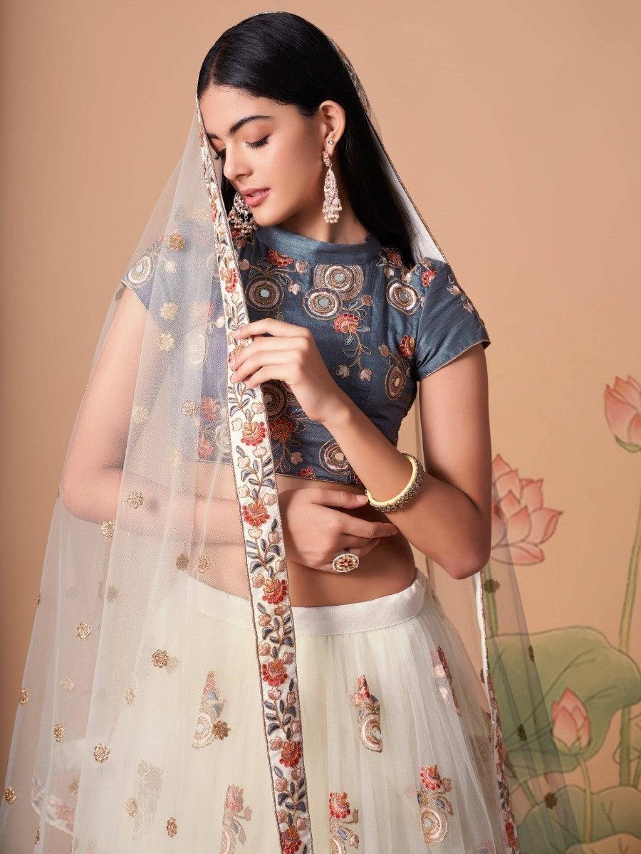 Semi-stitched off-white lehenga with intricate embroidery work.