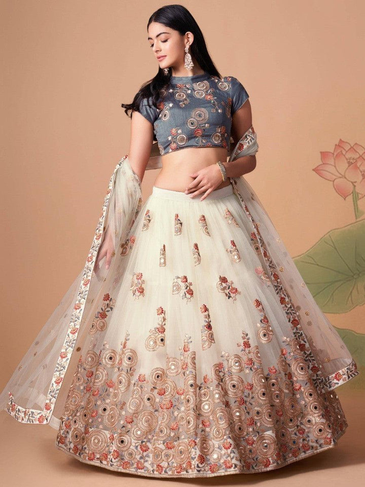 Off-white lehenga with mirror work and sequin detailing.