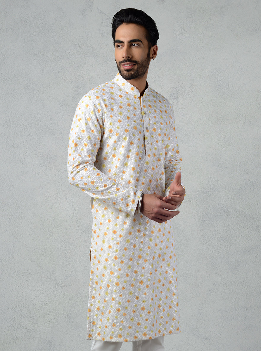 Discover elegance with our white & ochre yellow kurta set, featuring fine thread work for a standout appearance.