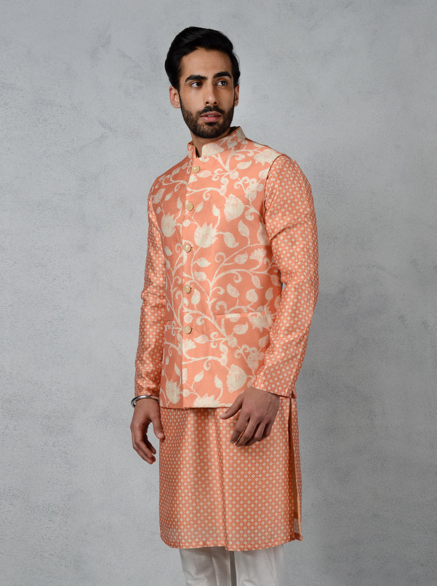 Make a statement in this stylish orange bandhgala jacket with glittered pearl buttons and floral design, ideal for special occasions.