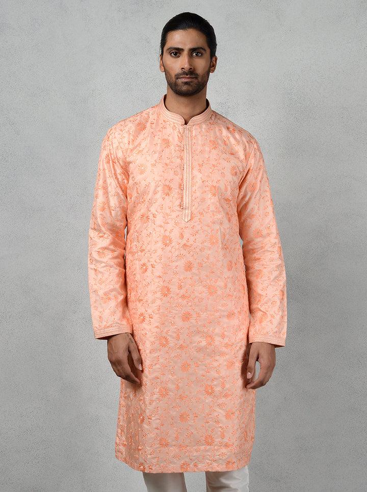 Chic peach kurta pajama for weddings and cultural gatherings.