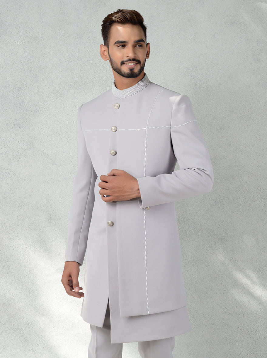 Stylish grey Indo-Western kurta for men with metal buttons and traditional cutdana embroidery.